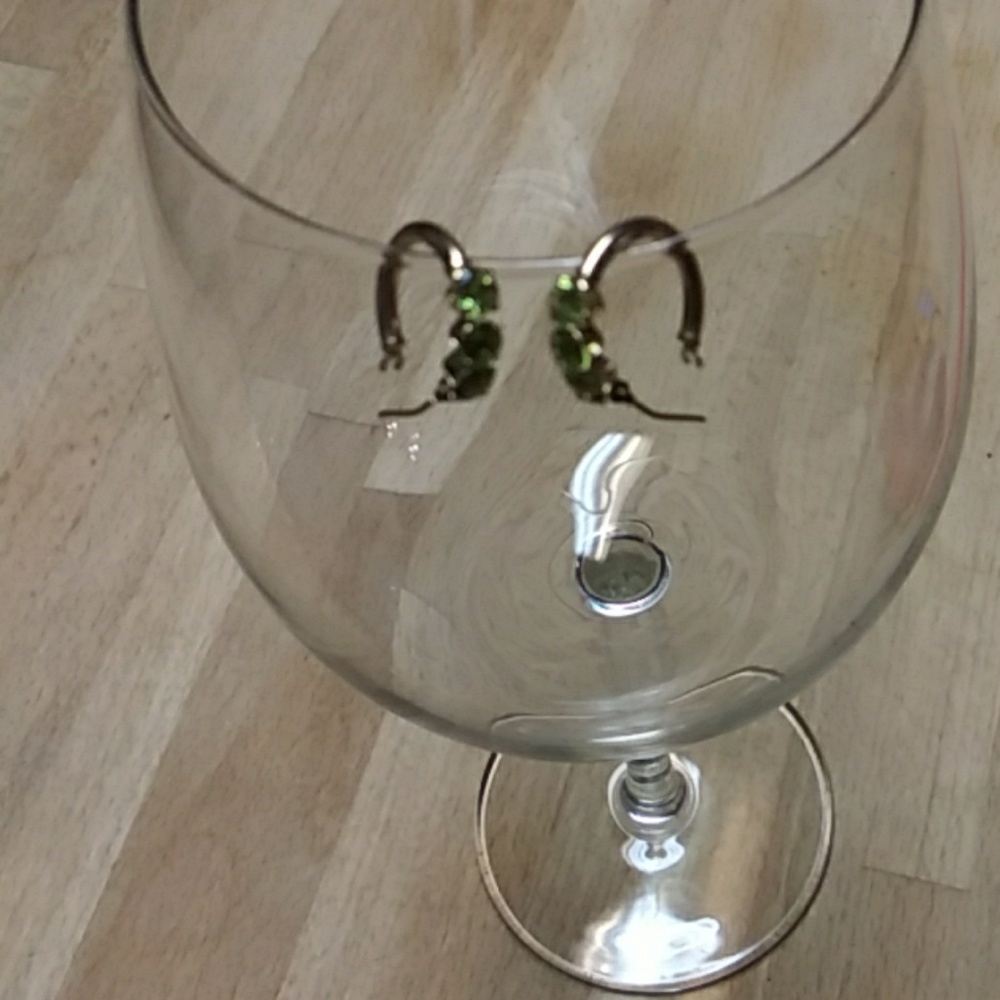 14kt Gold hoops with emerald green gemstones.
